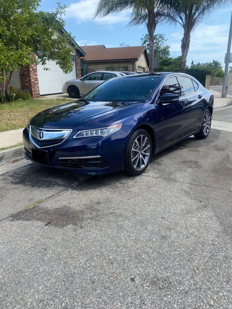 Dark blue Acura sedan parked in a driveway after a full interior and exterior detail