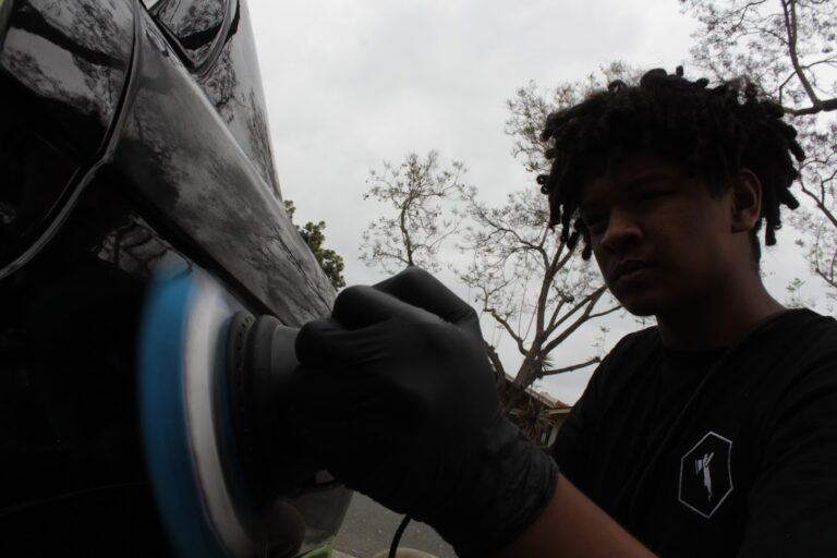 Polisher with a finishing pad on the paint during a one-step polish