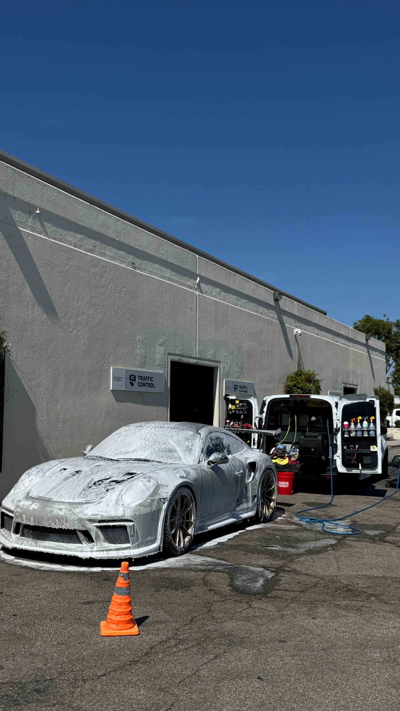 Pre-foam hand wash during the exterior detail, Automotive Aptitude van behind