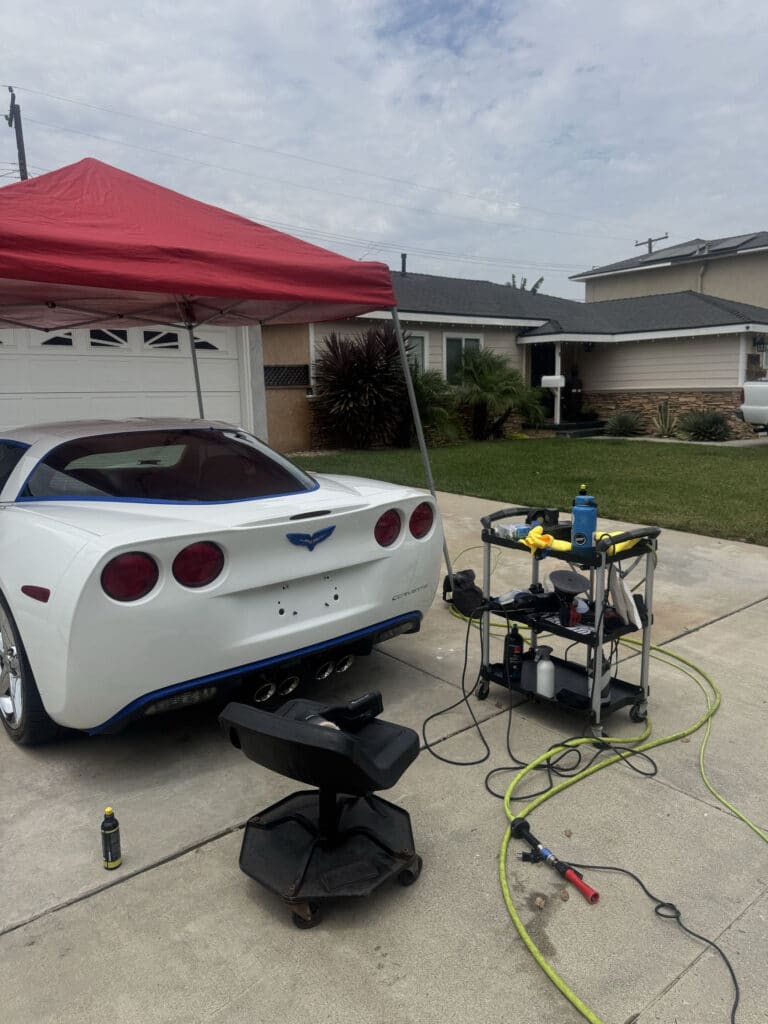White Chevrolet Corvette in a driveway after a three year ceramic coating